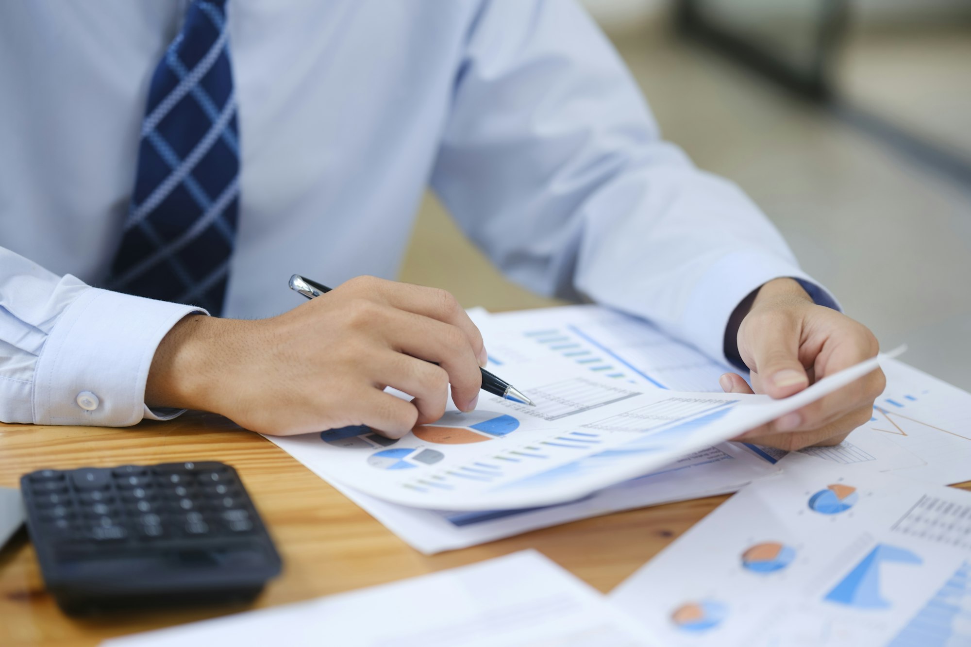 Businessman Analyzing Risk, Investment, and Market Data in the Office