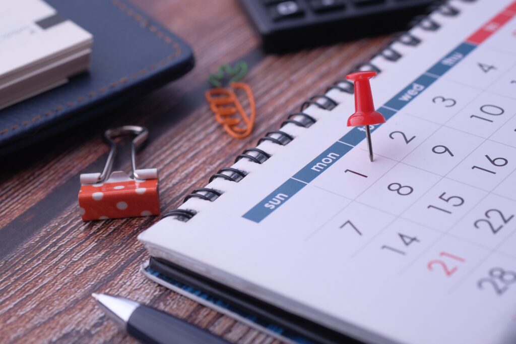 A tidy desk with a calendar and supplies, perfect for scheduling and task management