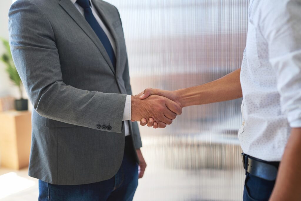 Business people shaking hands in office meeting welcoming gesture greeting client successful partne