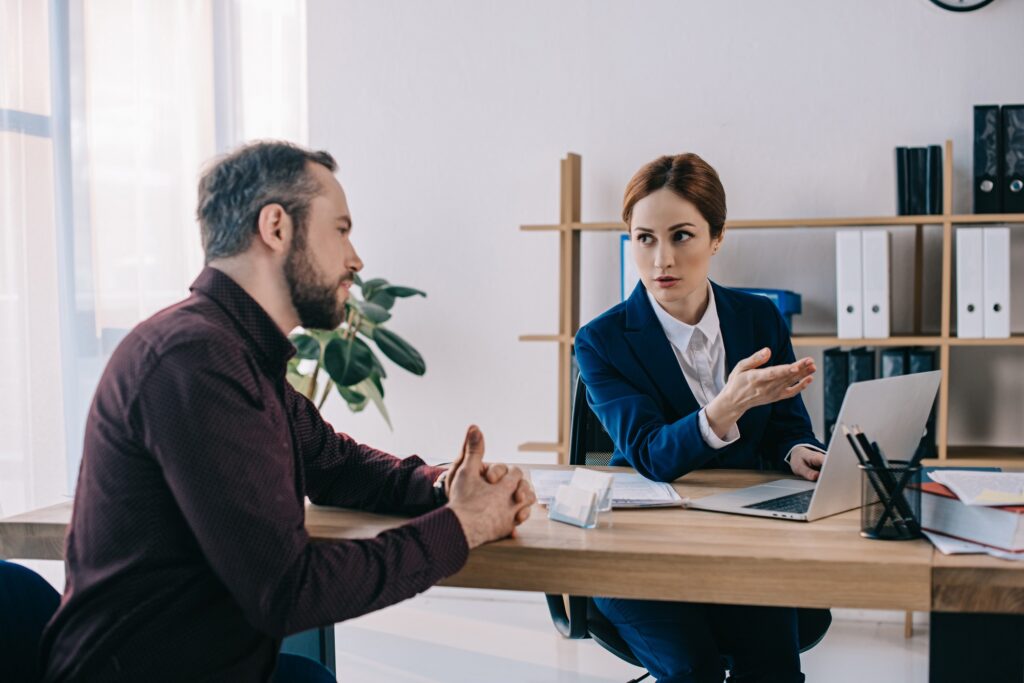 businesswoman and client discussing contract at workplace in office